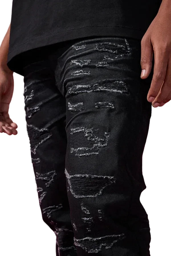Dyckman straight fit denim jeans in polished black with glossy coated finish and rip-and-repair detailing.