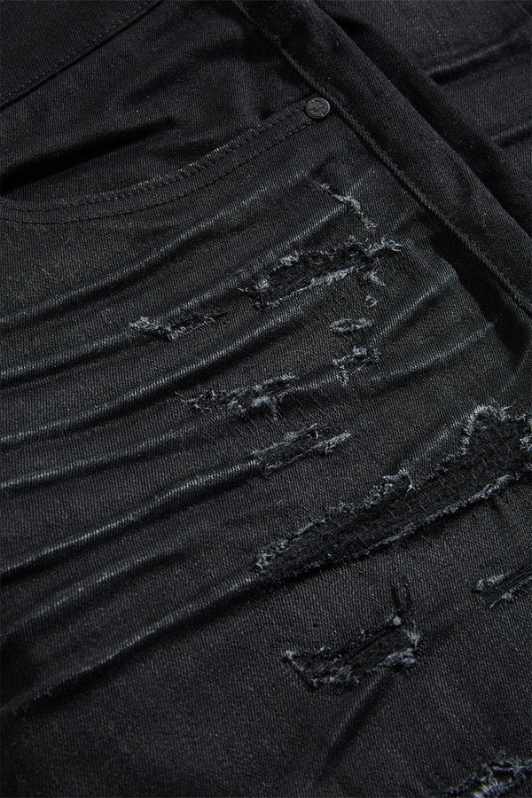 Dyckman straight fit denim jeans in polished black with glossy coated finish and rip-and-repair detailing.