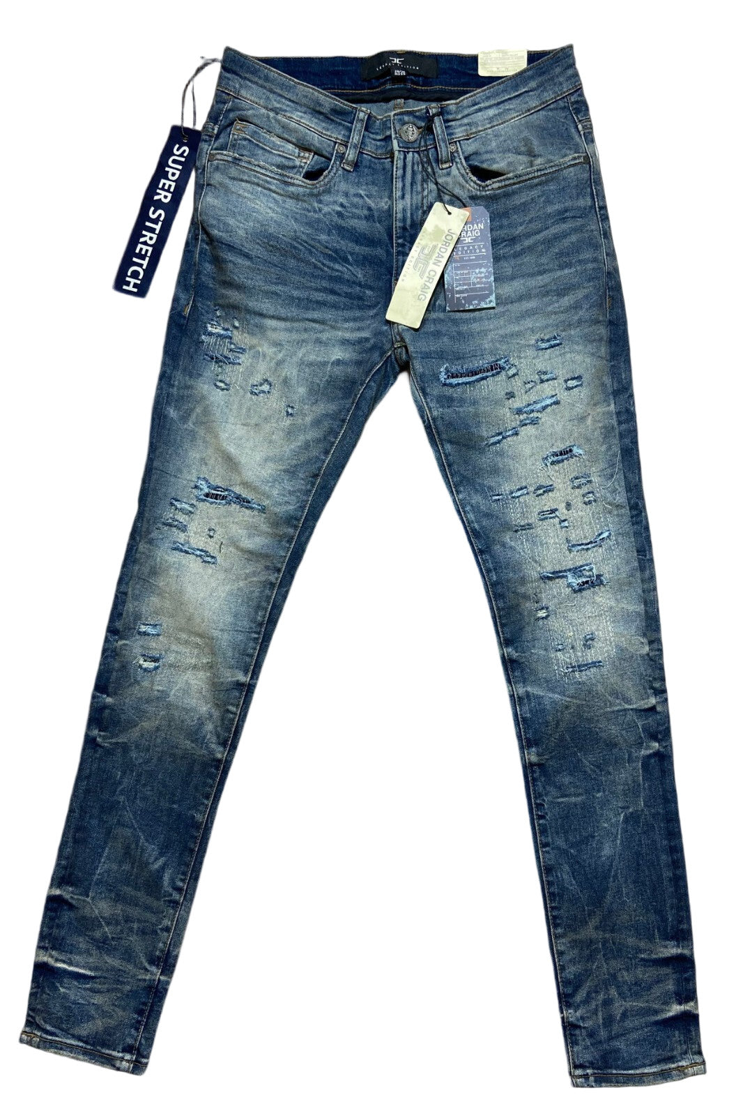Blue distressed jeans with tags on a white background