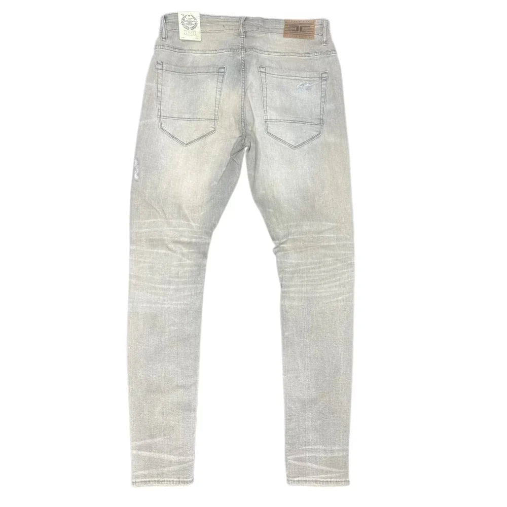 Extended-length flare denim pants with stacked leg, 3D baked wrinkles, and rip-and-repair detailing
