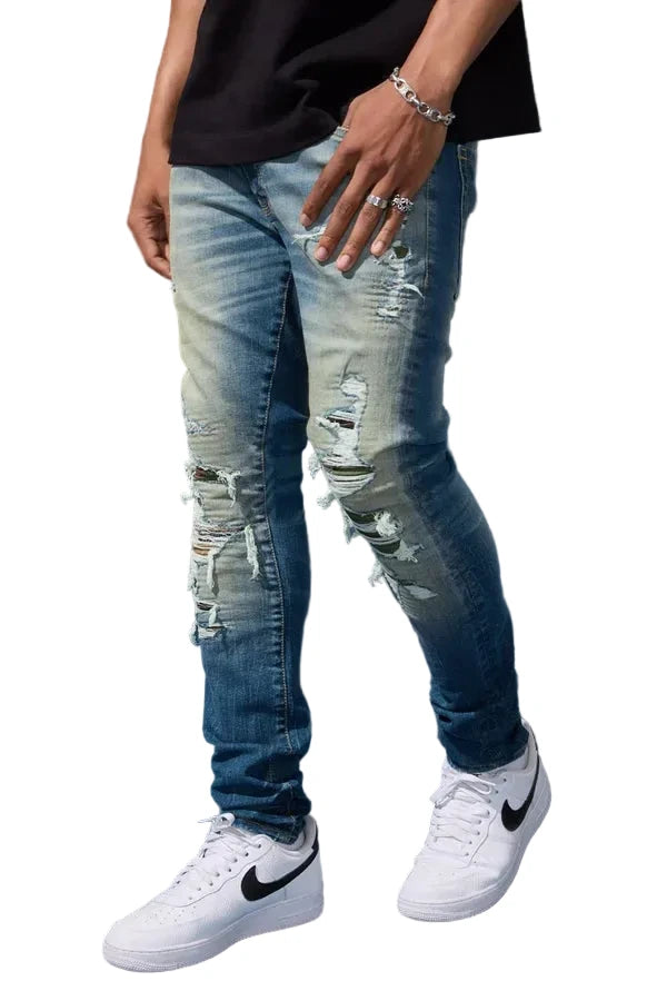 Jordan Craig Recon skinny fit denim in desert wash with rip and repair detailing, camo backing, and stretch denim streetwear style