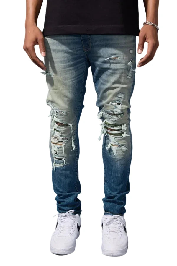 Jordan Craig Recon skinny fit denim in desert wash with rip and repair detailing, camo backing, and stretch denim streetwear style