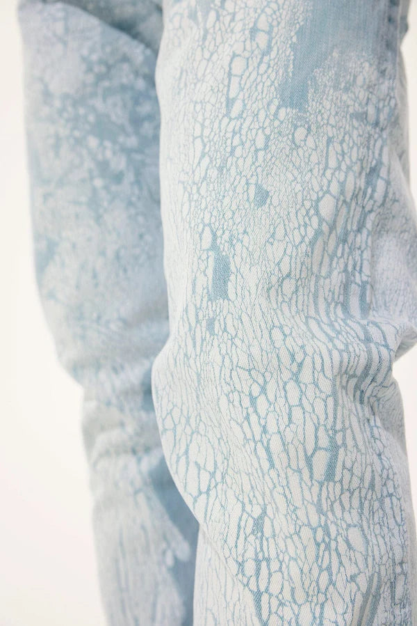  Slim taper fit jeans with cracking texture, regular rise, and stretch fabric for comfort.