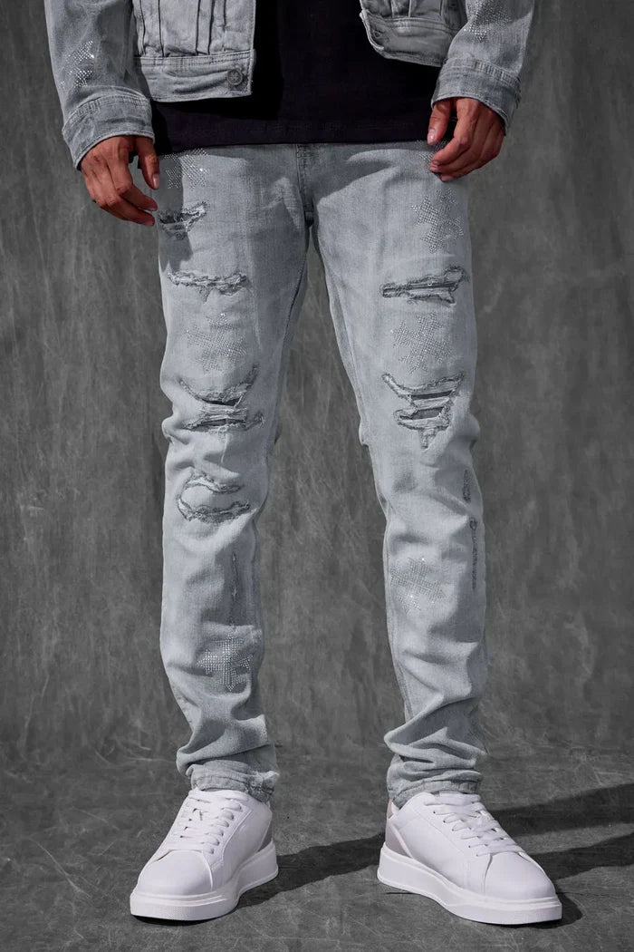 Crafted for a modern fit, the Men's Slim Taper Limelight Denim Pant by Jordan Craig offers a sleek silhouette that narrows from the thigh to the ankle. Made with durable denim, these pants balance style and comfort, ensuring they hold shape while allowing ease of movement. Ideal for those seeking a refined yet casual look, they pair well with both streetwear and smart-casual ensembles.