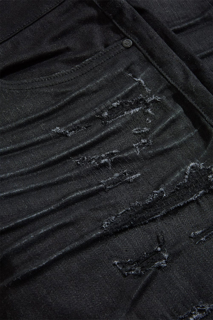 The Sean – Dyckman Denim brings together everything New York stands for — grit, polish, and presence. Designed in a sleek Polished Black color-way, these jeans feature a signature rip and repair design that gives them texture and depth without overdoing it. The subtle sheen finish adds a refined edge, making them just as ready for a late-night move as they are for an elevated night out. It’s denim that doesn’t just fit the look — it builds the mood. Cut in our Sean fit, this pair runs tapered with a modern 