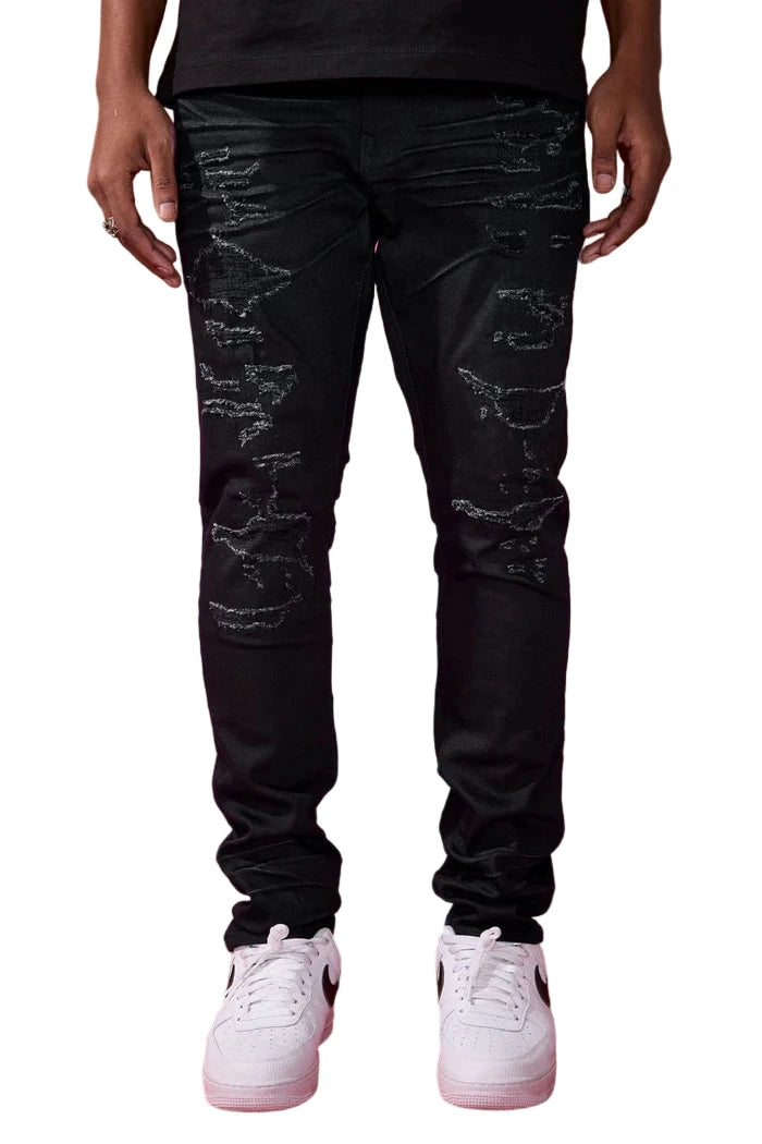 The Sean – Dyckman Denim brings together everything New York stands for — grit, polish, and presence. Designed in a sleek Polished Black color-way, these jeans feature a signature rip and repair design that gives them texture and depth without overdoing it. The subtle sheen finish adds a refined edge, making them just as ready for a late-night move as they are for an elevated night out. It’s denim that doesn’t just fit the look — it builds the mood. Cut in our Sean fit, this pair runs tapered with a modern 