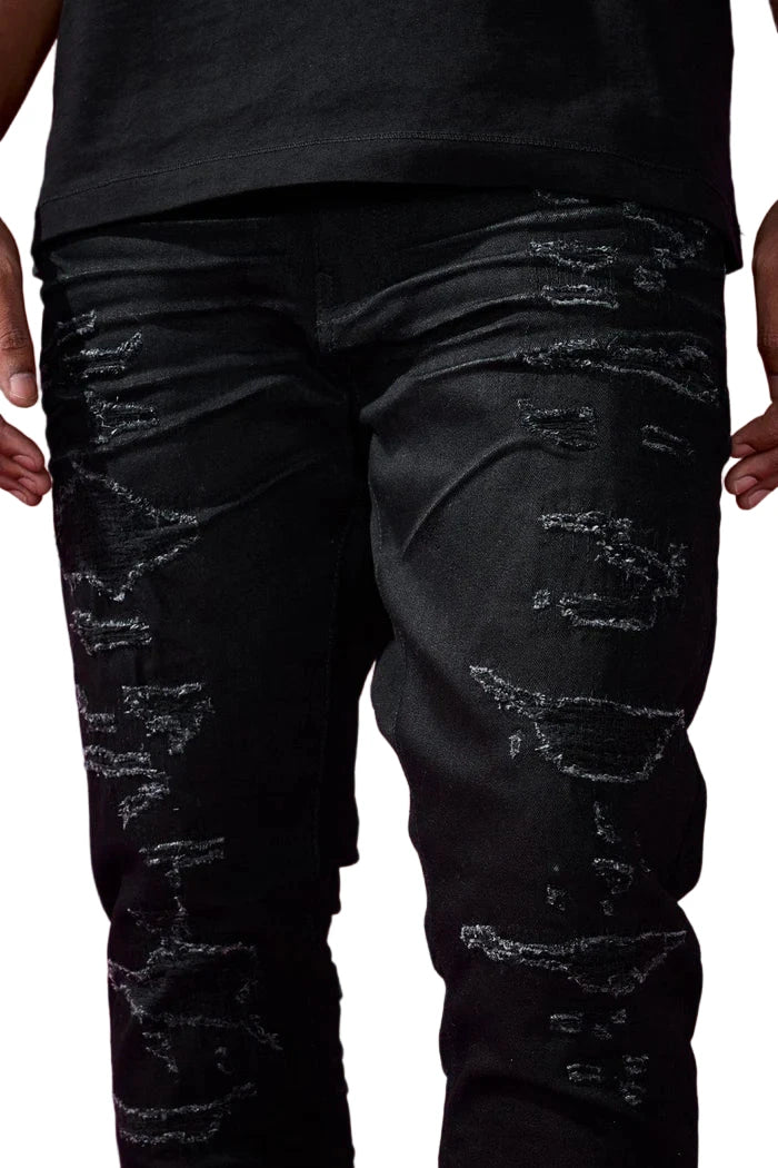 The Sean – Dyckman Denim brings together everything New York stands for — grit, polish, and presence. Designed in a sleek Polished Black color-way, these jeans feature a signature rip and repair design that gives them texture and depth without overdoing it. The subtle sheen finish adds a refined edge, making them just as ready for a late-night move as they are for an elevated night out. It’s denim that doesn’t just fit the look — it builds the mood. Cut in our Sean fit, this pair runs tapered with a modern 