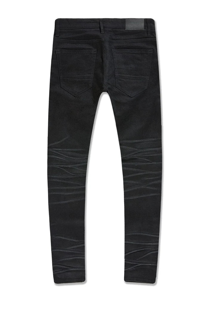 The Sean – Dyckman Denim brings together everything New York stands for — grit, polish, and presence. Designed in a sleek Polished Black color-way, these jeans feature a signature rip and repair design that gives them texture and depth without overdoing it. The subtle sheen finish adds a refined edge, making them just as ready for a late-night move as they are for an elevated night out. It’s denim that doesn’t just fit the look — it builds the mood. Cut in our Sean fit, this pair runs tapered with a modern 