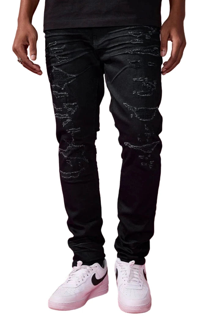 The Sean – Dyckman Denim brings together everything New York stands for — grit, polish, and presence. Designed in a sleek Polished Black color-way, these jeans feature a signature rip and repair design that gives them texture and depth without overdoing it. The subtle sheen finish adds a refined edge, making them just as ready for a late-night move as they are for an elevated night out. It’s denim that doesn’t just fit the look — it builds the mood. Cut in our Sean fit, this pair runs tapered with a modern 