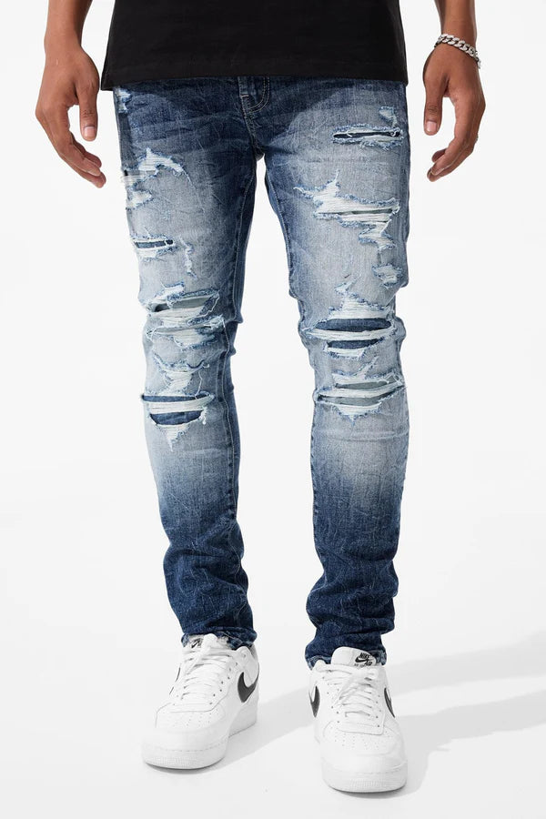  Slim taper fit super stretch jeans with rip-and-repair styling, fused shreds, and vintage distressing
