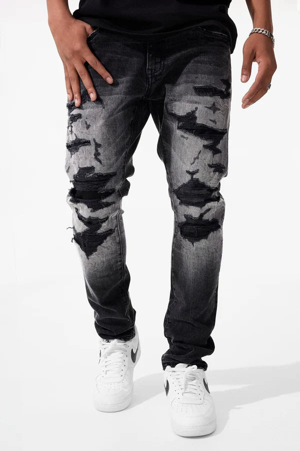  Slim taper fit super stretch jeans with rip-and-repair styling, fused shreds, and vintage distressing