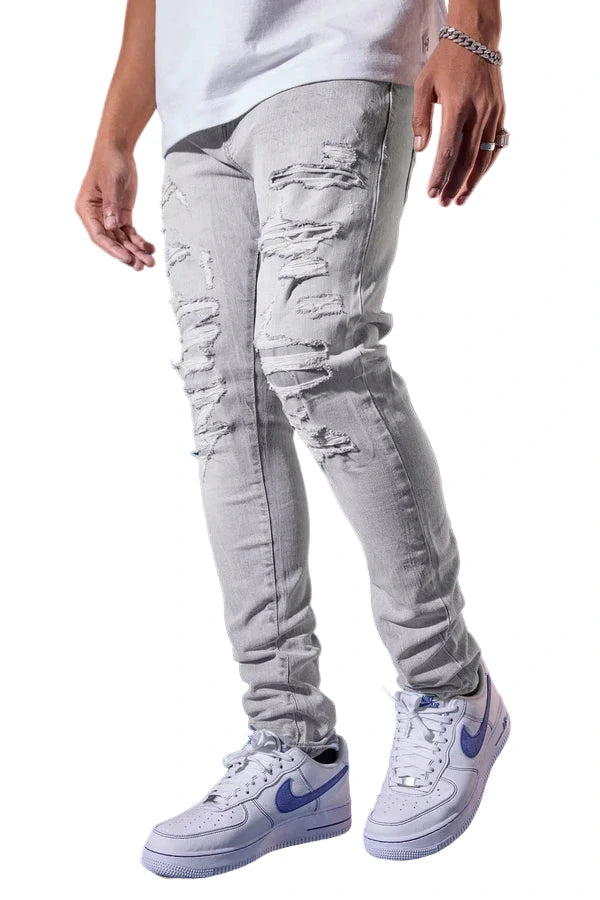  Slim taper fit jeans with rip-and-repair design, fused shreds, and unique vintage distressing