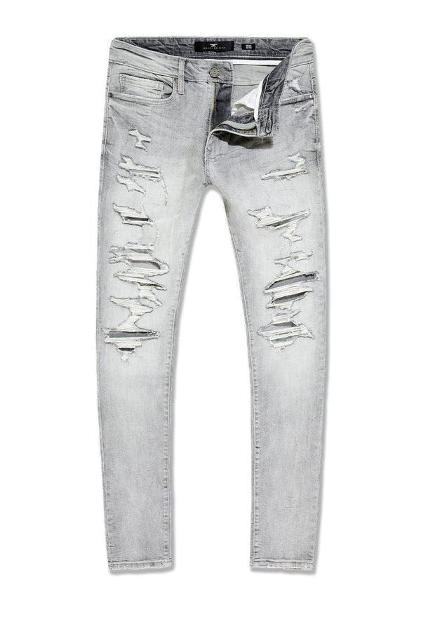  Slim taper fit jeans with rip-and-repair design, fused shreds, and unique vintage distressing
