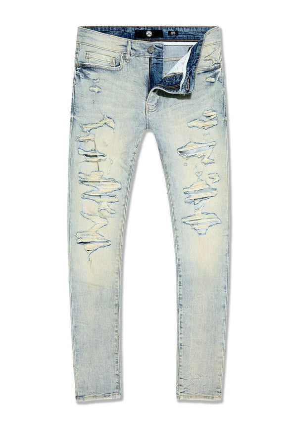  Slim taper fit jeans with rip-and-repair design, fused shreds, and unique vintage distressing