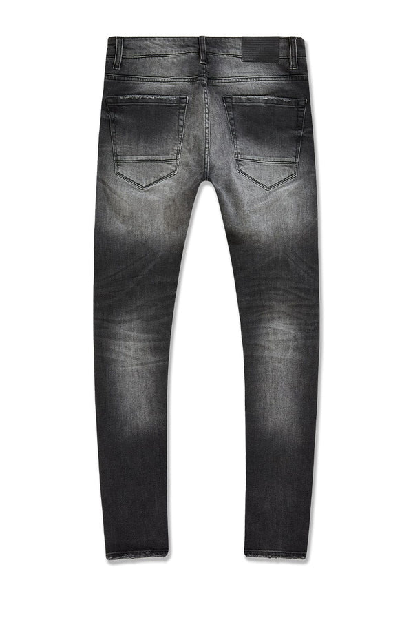 Slim taper fit denim jeans with rip-and-repair detailing and vintage-inspired distressing.