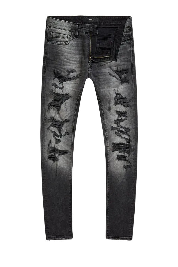 Slim taper fit denim jeans with rip-and-repair detailing and vintage-inspired distressing.