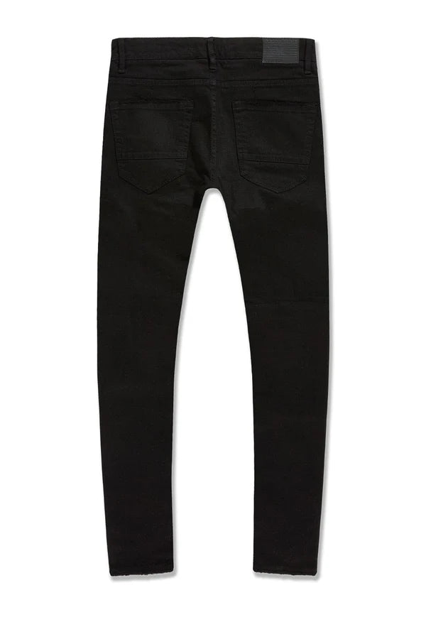 Alkaline Denim slim taper fit jeans in jet black with rip-and-repair detailing and vintage-inspired distressing.