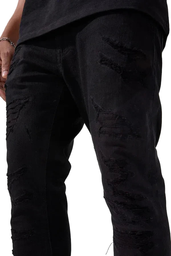 Alkaline Denim slim taper fit jeans in jet black with rip-and-repair detailing and vintage-inspired distressing.