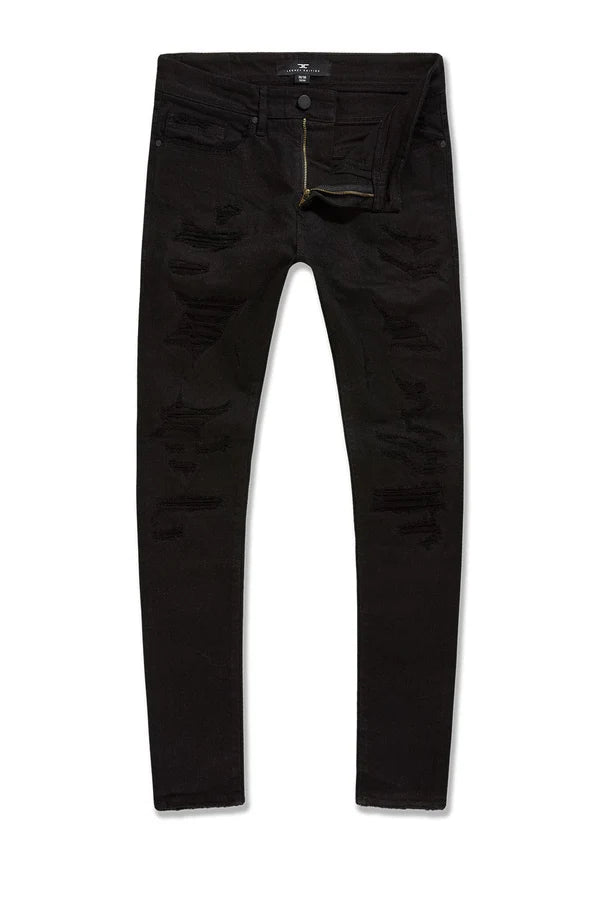 Alkaline Denim slim taper fit jeans in jet black with rip-and-repair detailing and vintage-inspired distressing.
