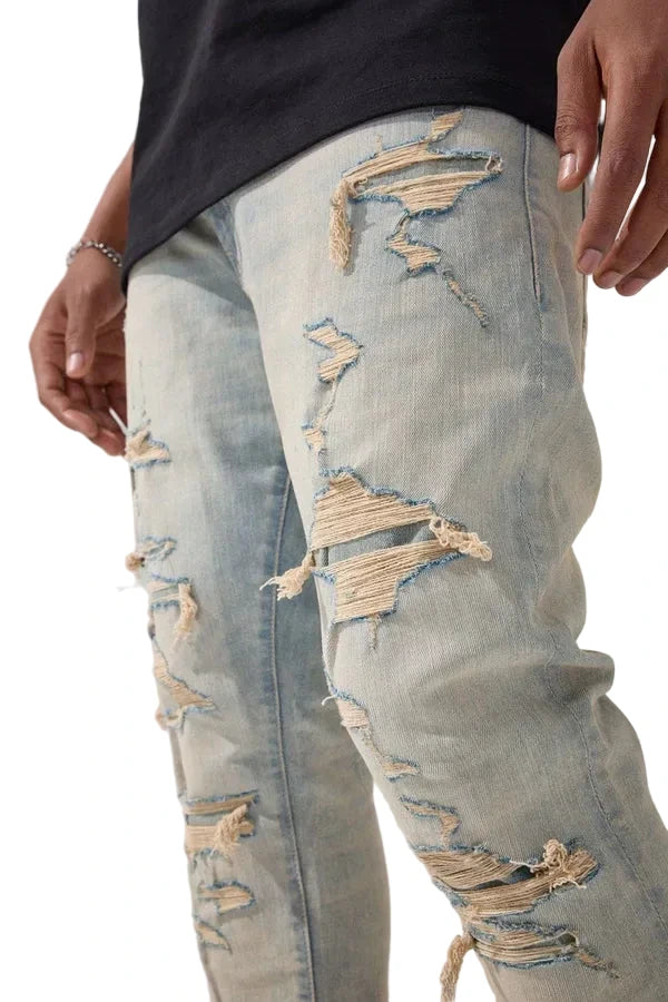 Jordan Craig Newport denim jeans in slim taper fit with distressed rip-and-repair details, 3D wrinkles, and modern stretch fabric