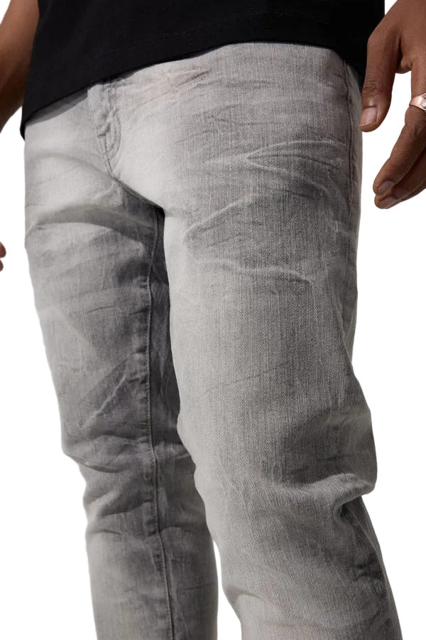 Slim taper fit jeans with 3D baked wrinkles, unique wash effect, and super stretch cotton Lycra fabric