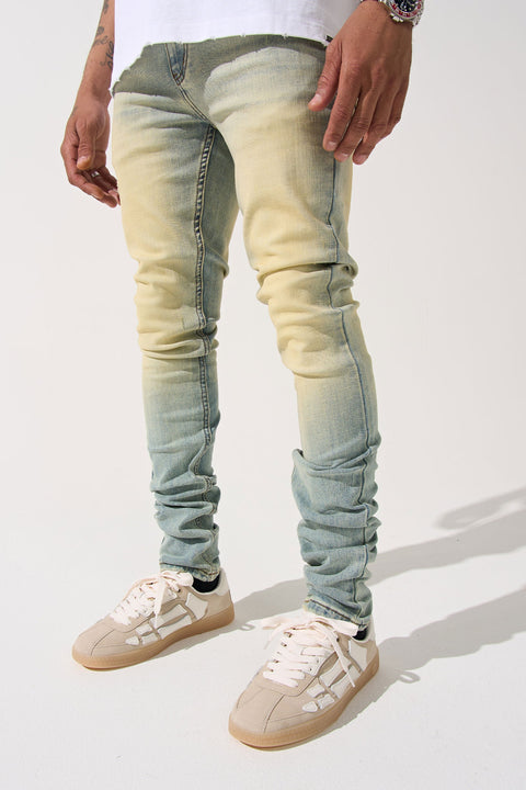 SERENEDE® LIMESTONE Jeans in vintage earth yellow with fitted construction, overdyed finish, fading, and embroidered [S]® logo.