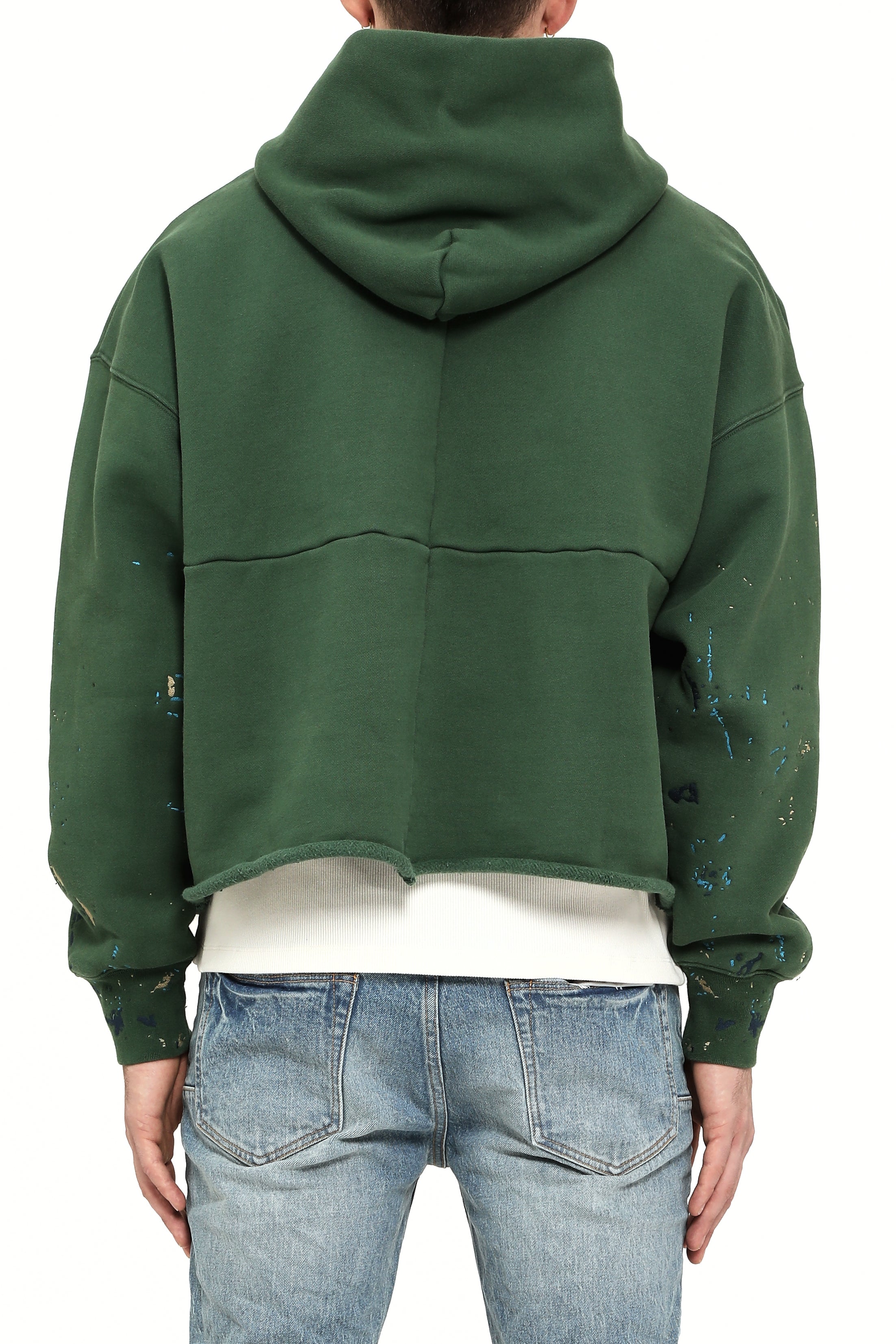 Green hoodie worn by a person on a white background