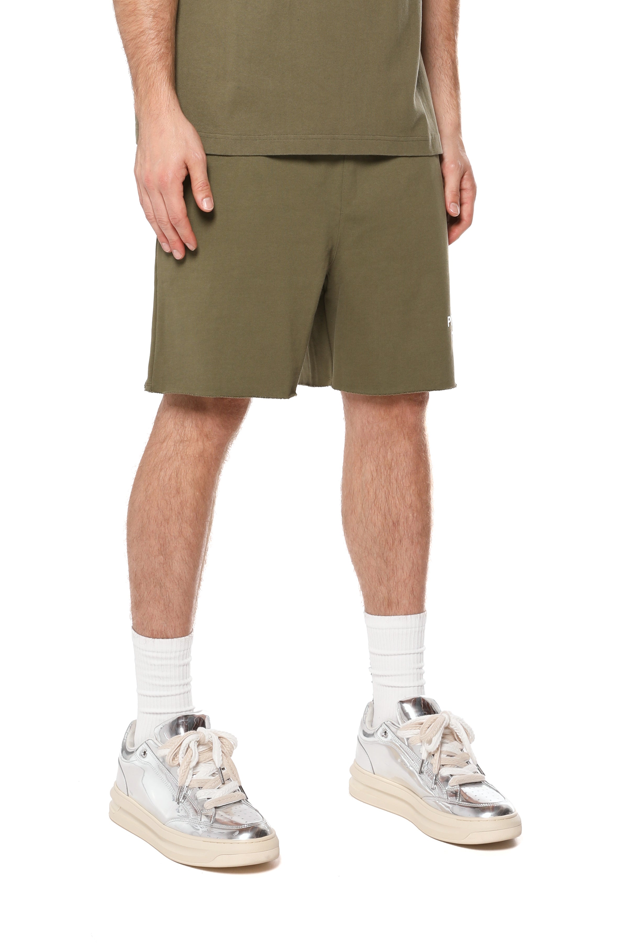 Purple Brand olive green French terry shorts made from heavyweight 100% cotton with a drawstring waistband, wordmark logo, rolled hems, and side pockets.