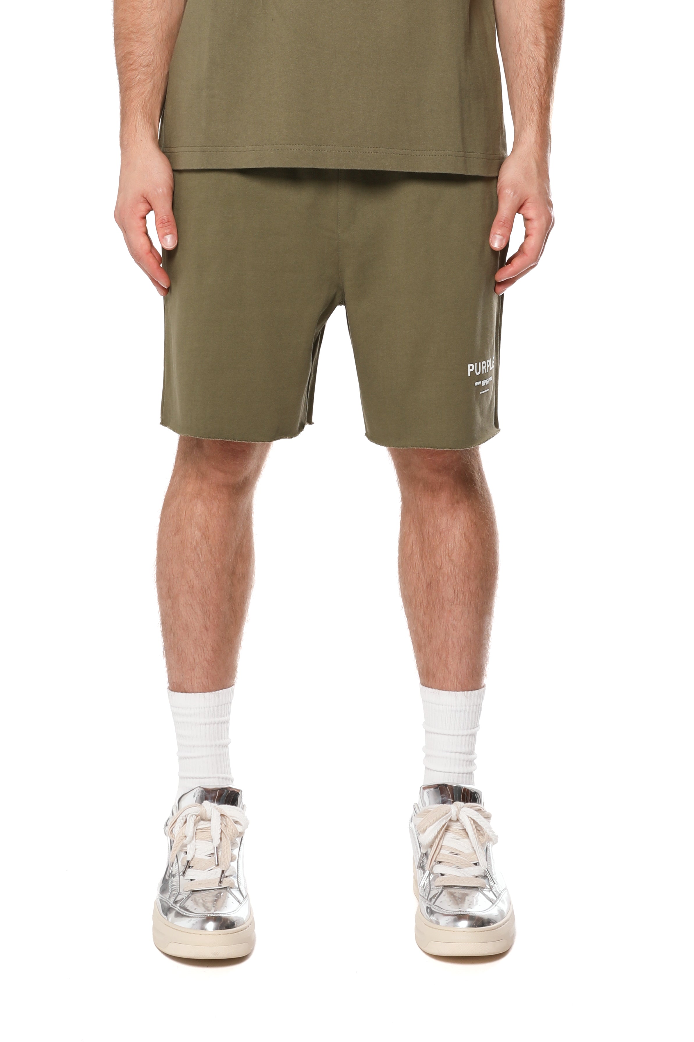 Purple Brand olive green French terry shorts made from heavyweight 100% cotton with a drawstring waistband, wordmark logo, rolled hems, and side pockets.
