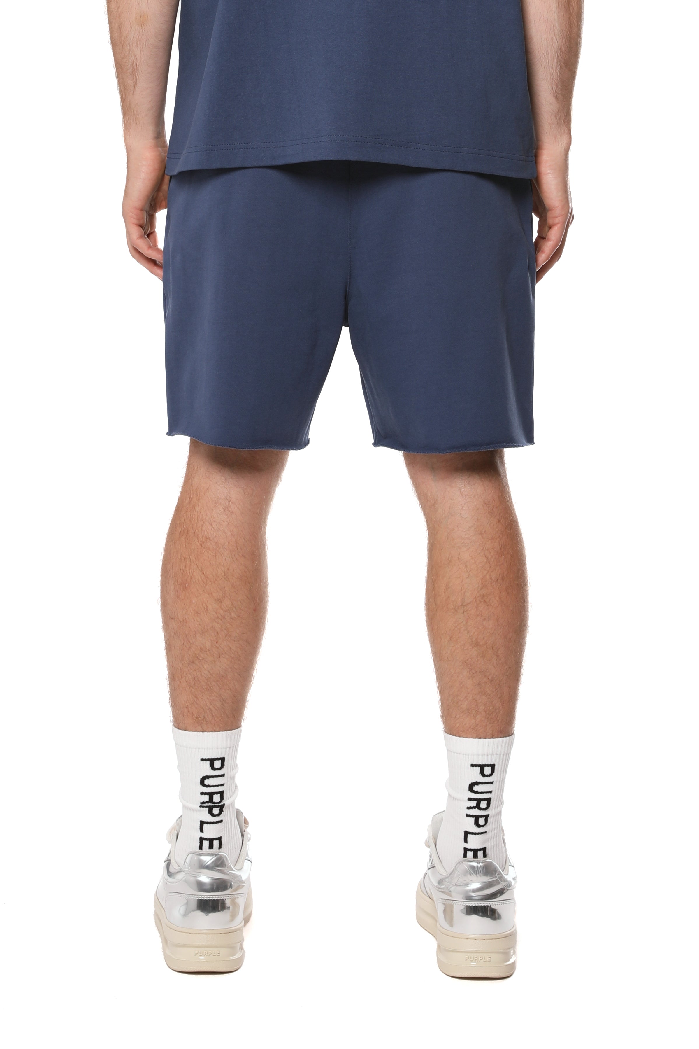 Purple Brand cotton sweat shorts featuring logo lettering on the front legs, a drawstring waistband, raw-edge hem, and two hand pockets.