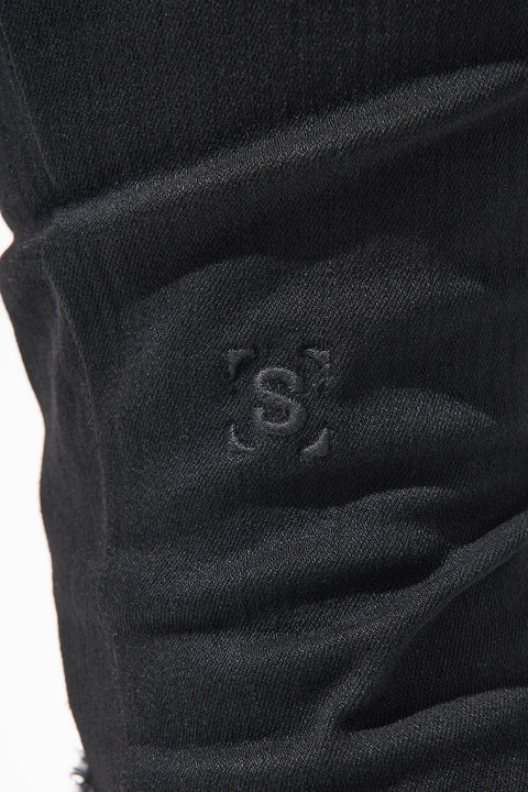 SERENEDE® Midnight Black skinny jeans in jet-black wash with high-stretch material, distressing, and branded hardware.