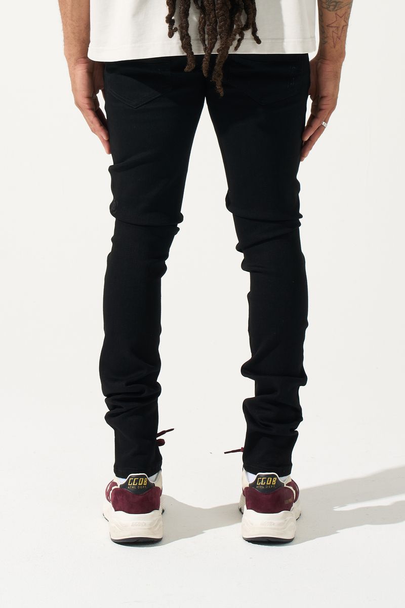SERENEDE® Midnight Black skinny jeans in jet-black wash with distressed detailing and signature leather waistband patch.