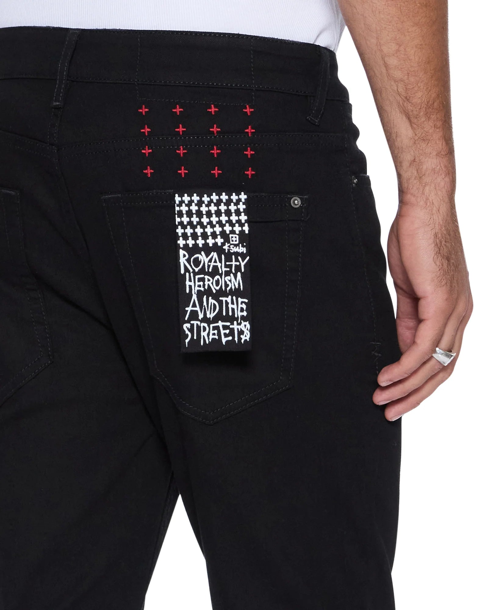 Van Winkle Laid Black Sting skinny jeans in black denim with knee deconstruction, seasonal printed art, and Ksubi signature embroidery