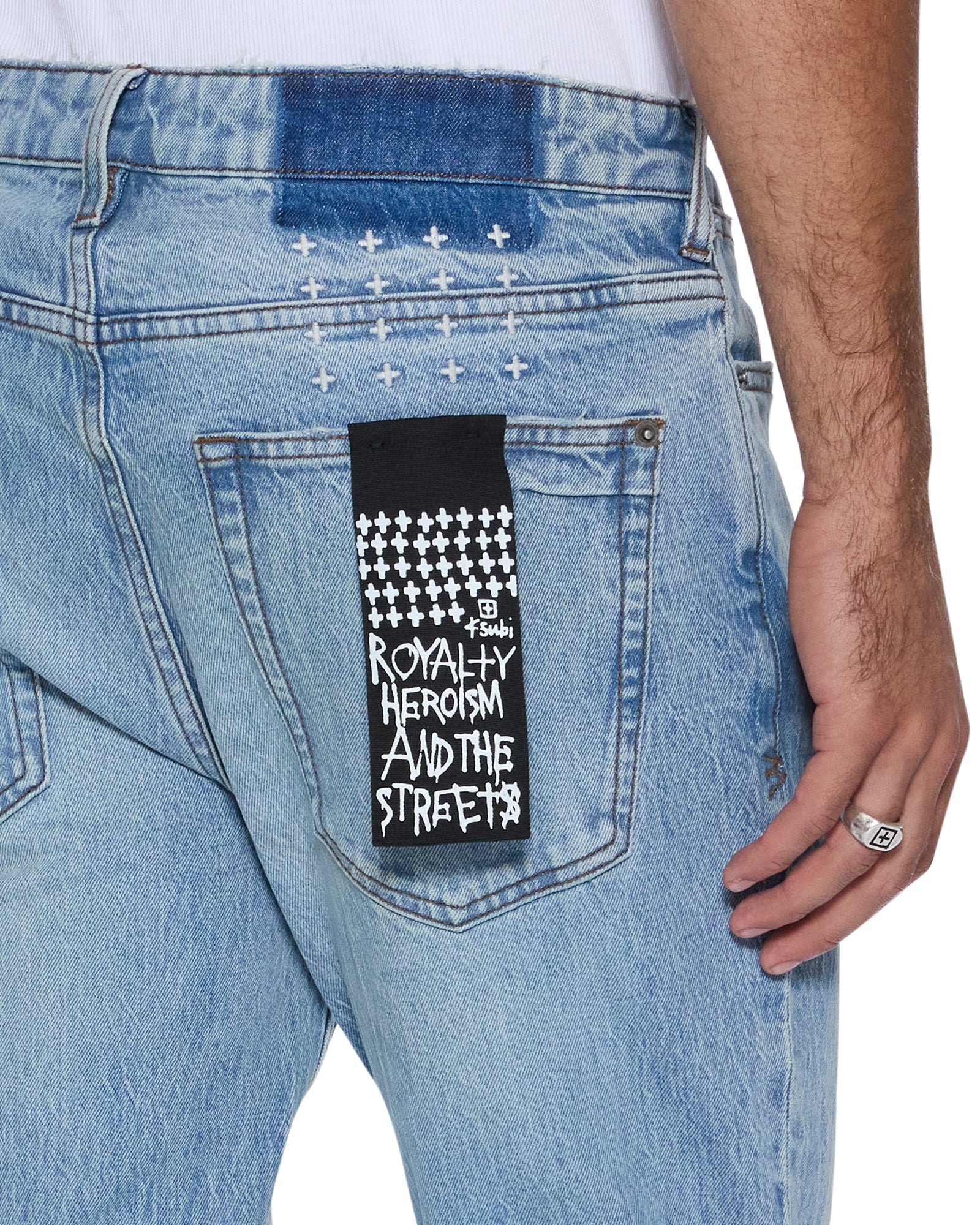 Van Winkle Painter 1999 mid-rise skinny jeans with medium stone wash, boucle knee patch, and Ksubi signature embroidery