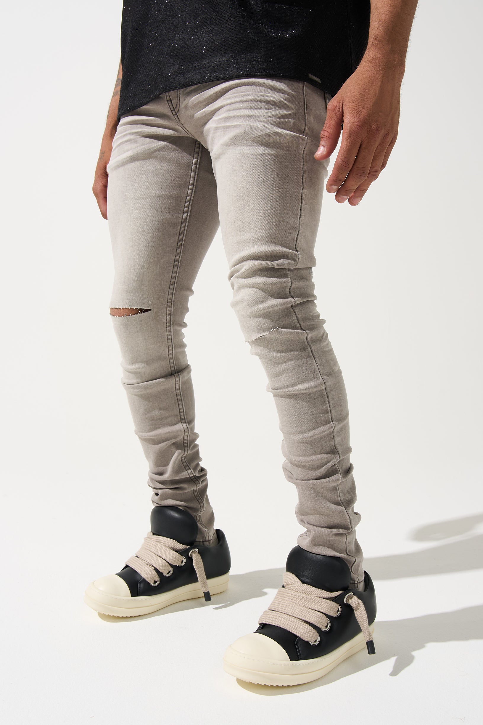 SERENEDE Marine Layer Jeans in cool grey wash with minimal knee distressing and skinny fit.