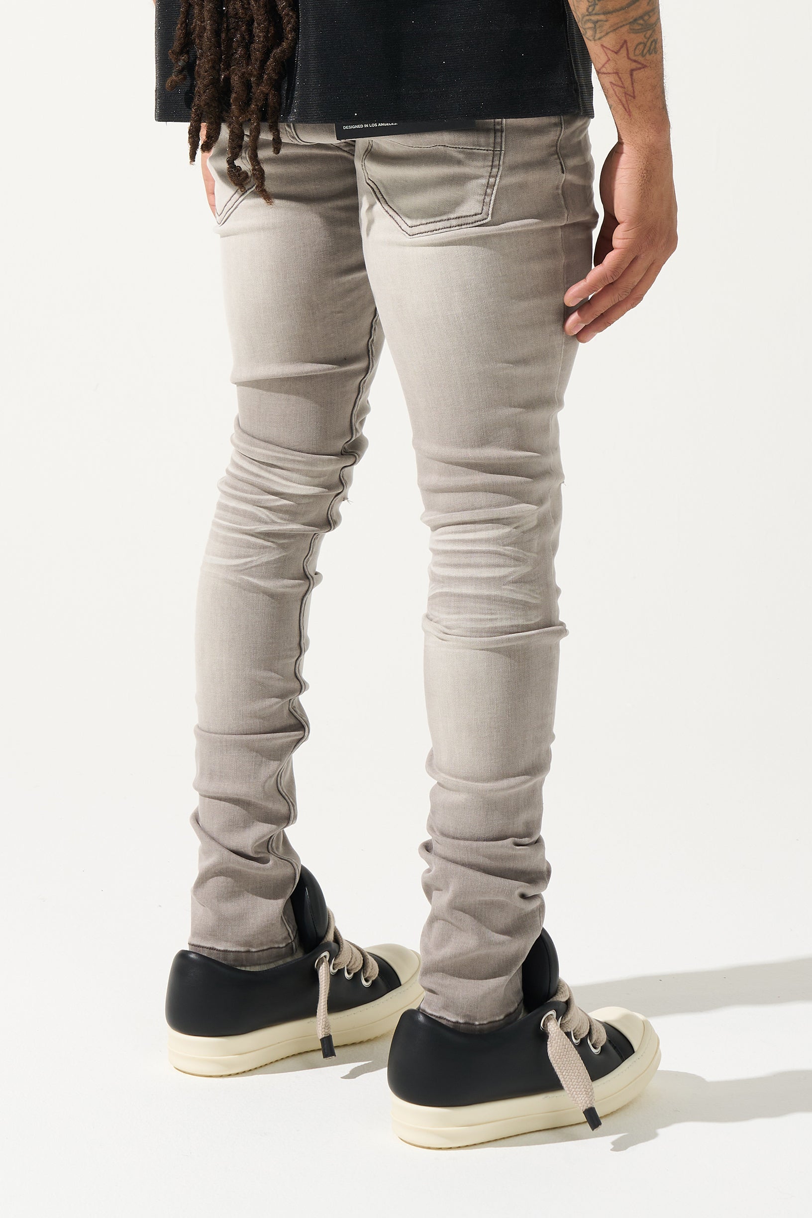 SERENEDE Marine Layer Jeans in cool grey wash with minimal knee distressing and skinny fit.
