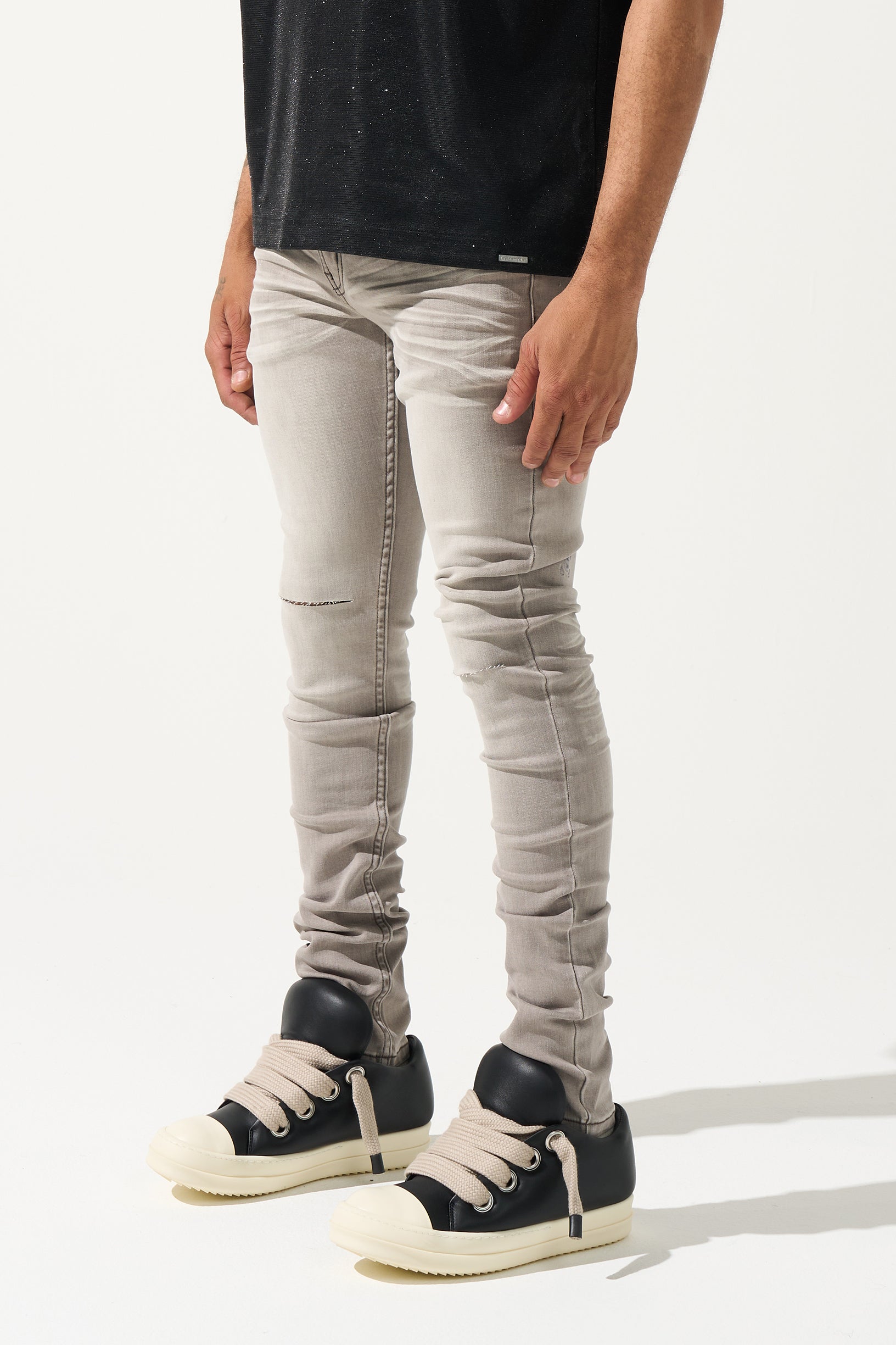SERENEDE Marine Layer Jeans in cool grey wash with minimal knee distressing and skinny fit.