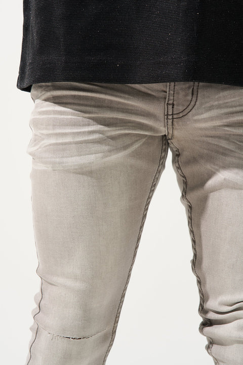 SERENEDE Marine Layer Jeans in cool grey wash with minimal knee distressing and skinny fit.