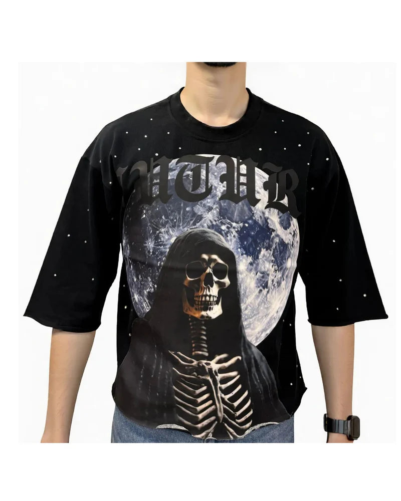 Black t-shirt with skeleton design and moon in front of a person on a white background