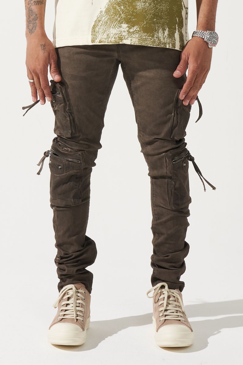 SERENEDE® OUD cargo jeans in brown overdye with fitted silhouette, cargo pockets, and branded leather waistband patch.