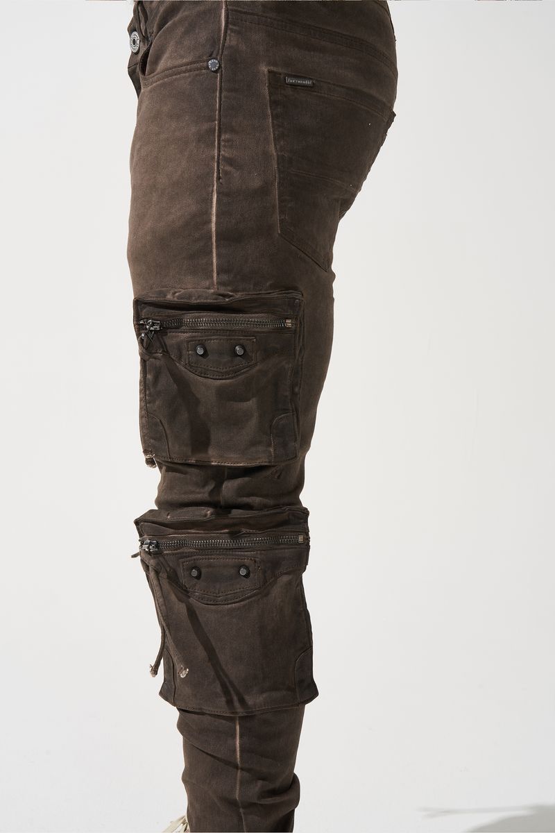 SERENEDE® OUD cargo jeans in brown overdye with fitted silhouette, cargo pockets, and branded leather waistband patch.