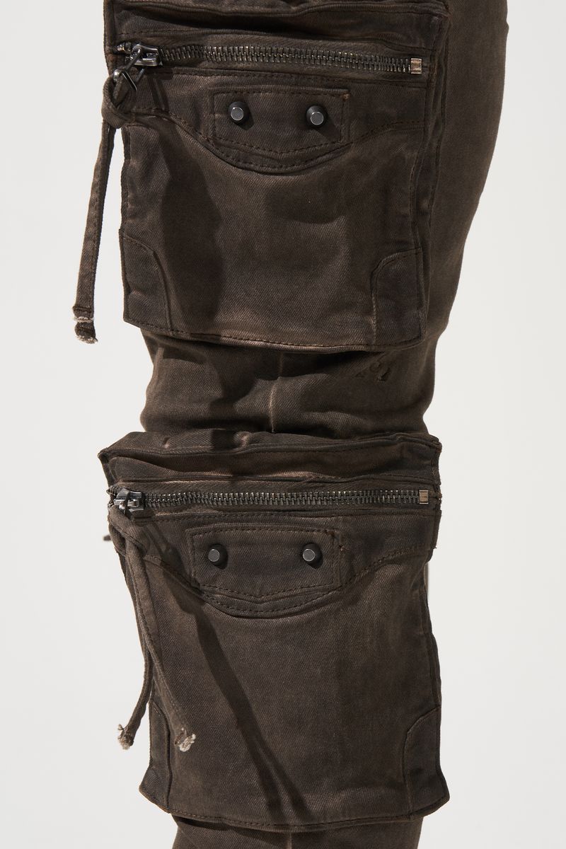 SERENEDE® OUD cargo jeans in brown overdye with fitted silhouette, cargo pockets, and branded leather waistband patch.