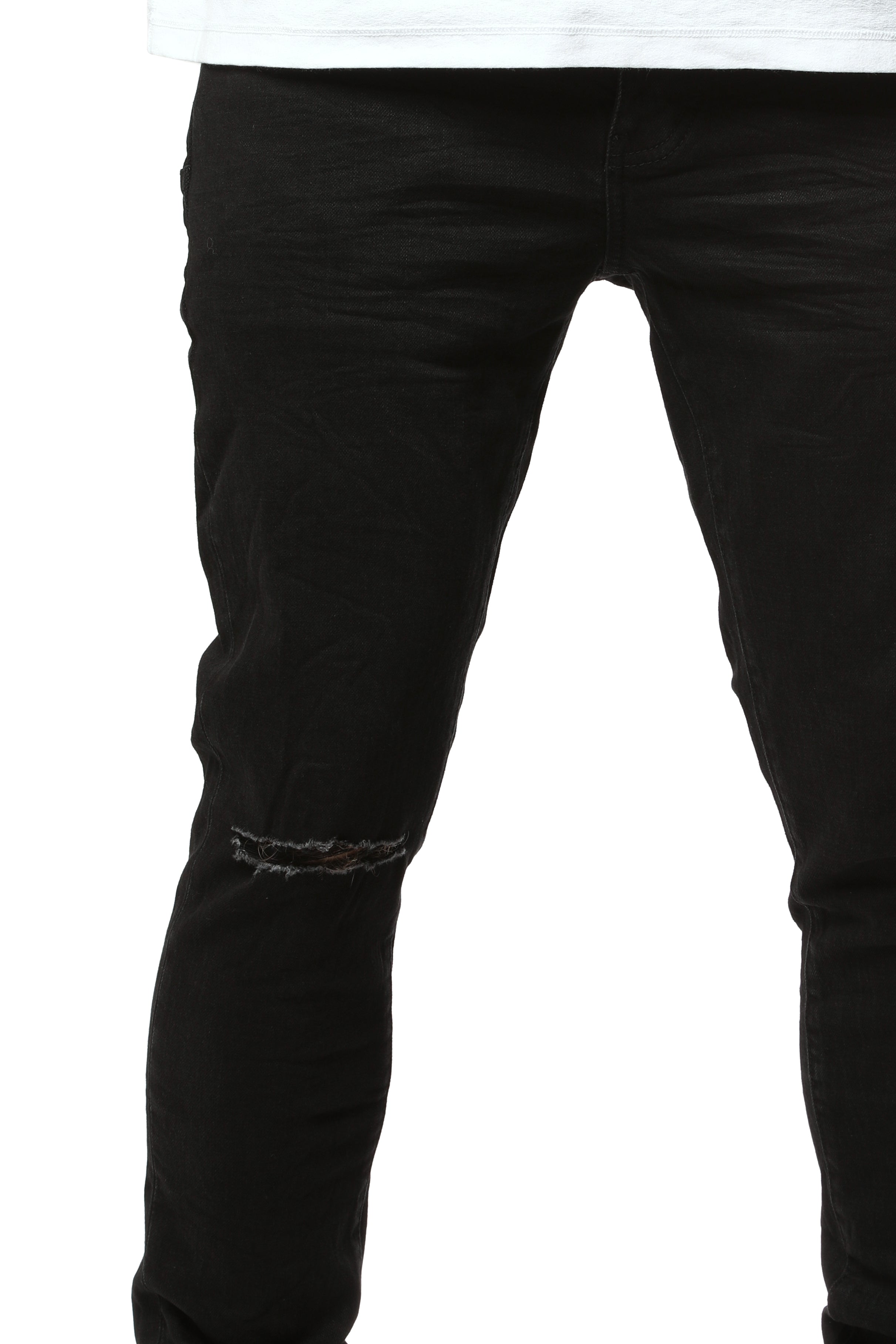 Purple Brand Core White Label Light Indigo skinny jeans with abrasions, repairs, hand-finished washes, and branded leather patch, featuring reinforced stitching and a low-rise fit.