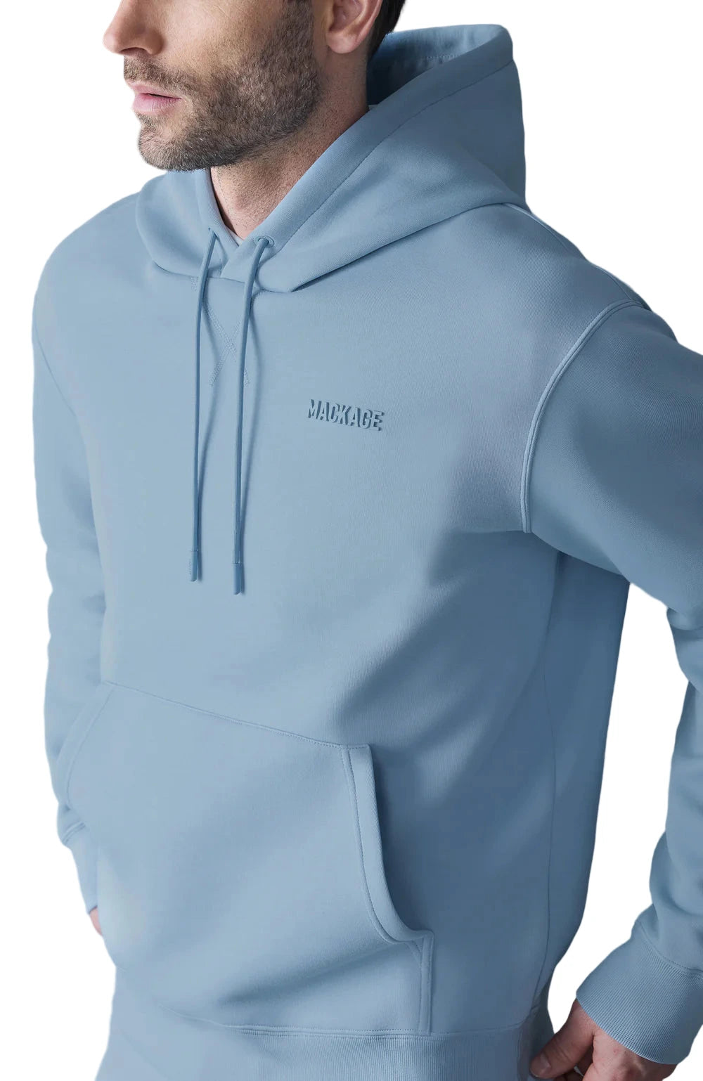 The Krystian Hoodie redefines everyday comfort with elevated craftsmanship. Designed in ultra-soft double-face jersey, it features a relaxed fit with a drop-shoulder cut for a laid-back, premium look. A kangaroo pocket, adjustable drawcord hood, and rib-knit trims offer timeless function, while the signature “MACKAGE” silicone logo at the chest adds a modern touch. Perfect for refined streetwear or upscale loungewear.