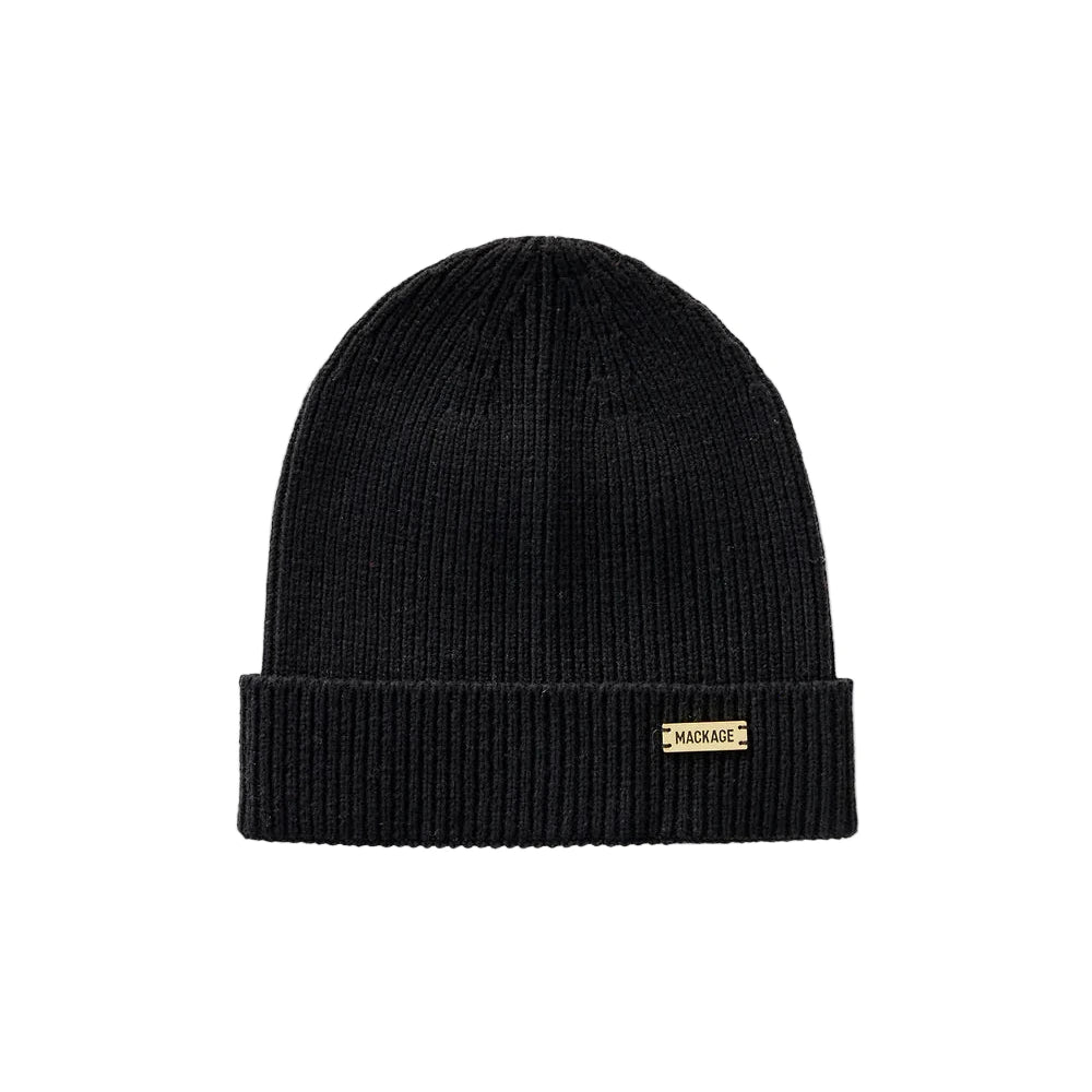 Black beanie with a gold tag on a light gray background