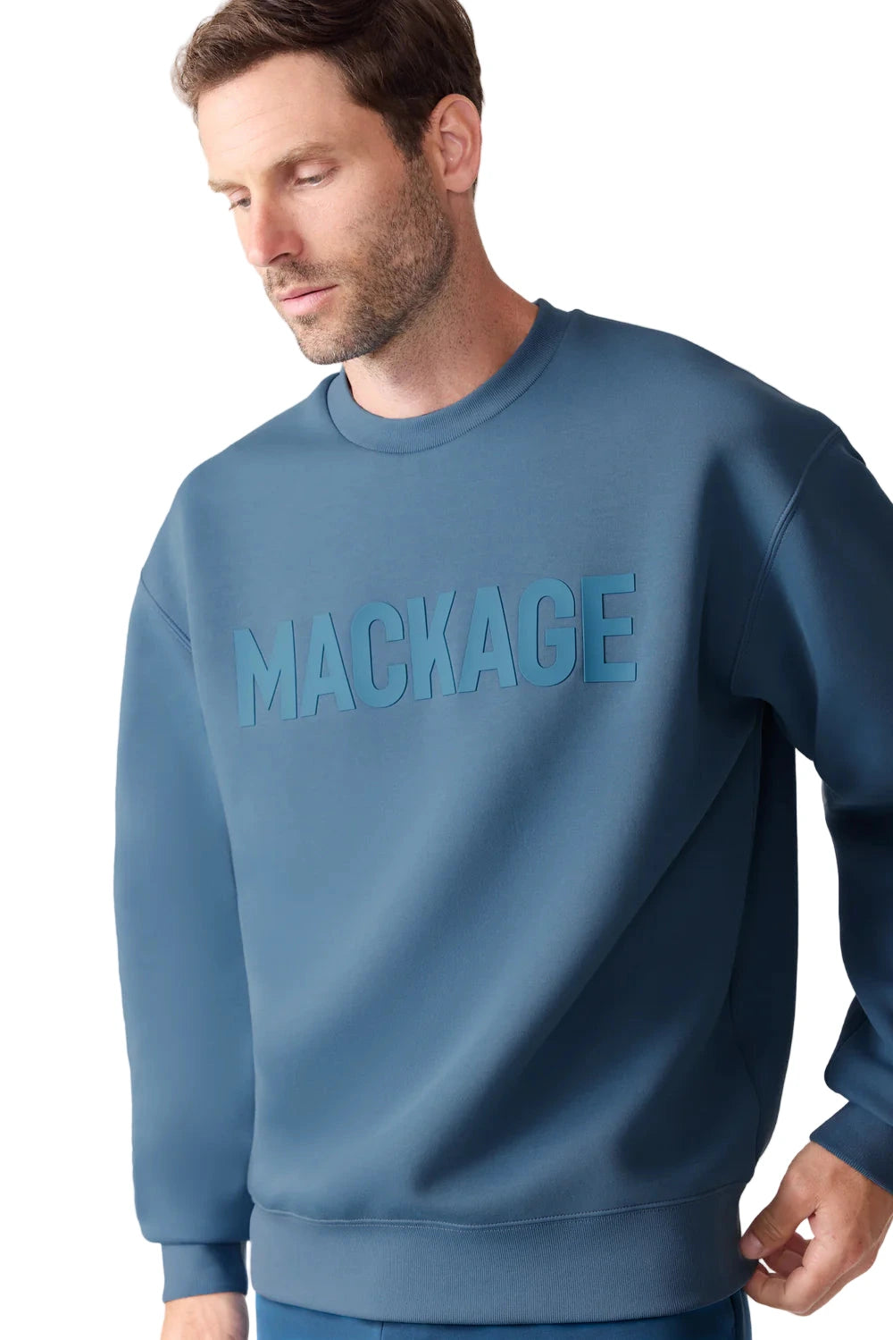 The Julius sweatshirt from MACKAGE is crafted from premium double-face jersey for a sleek yet comfortable feel. Featuring the brand’s signature silicone logo at the chest, this crewneck combines modern minimalism with refined craftsmanship. Complete with rib-knit collar, cuffs, and hem, it delivers a clean silhouette ideal for casual or layered looks.