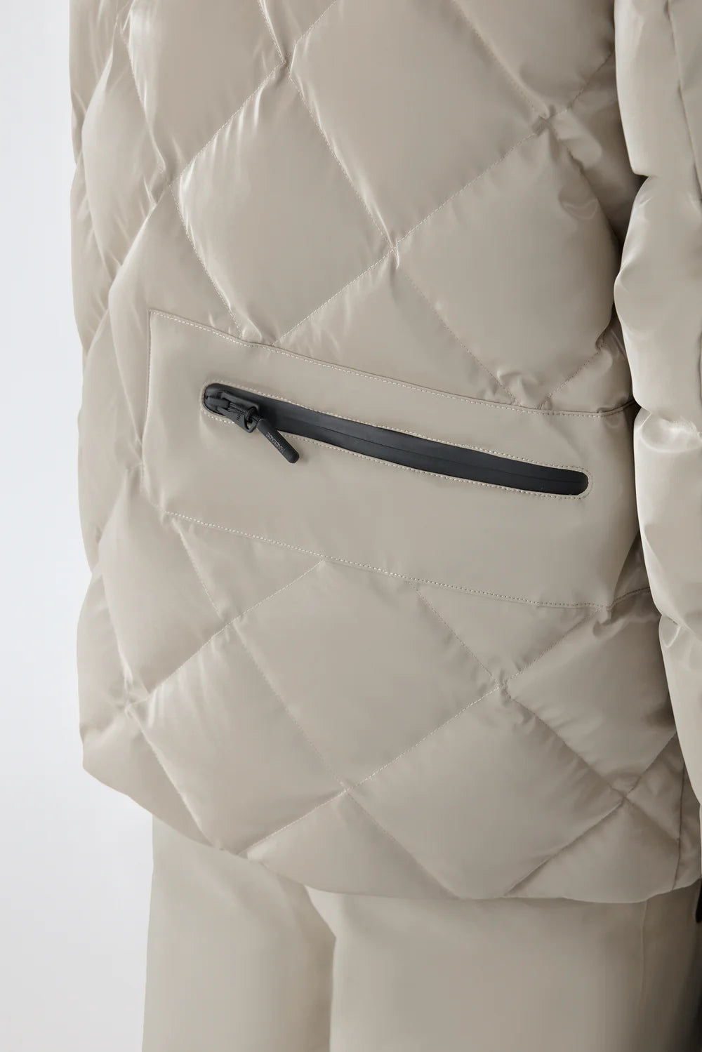 Mackage CILLIAN-GLO high-gloss quilted ski jacket with removable storm hood, powder skirt, and multiple utility pockets.