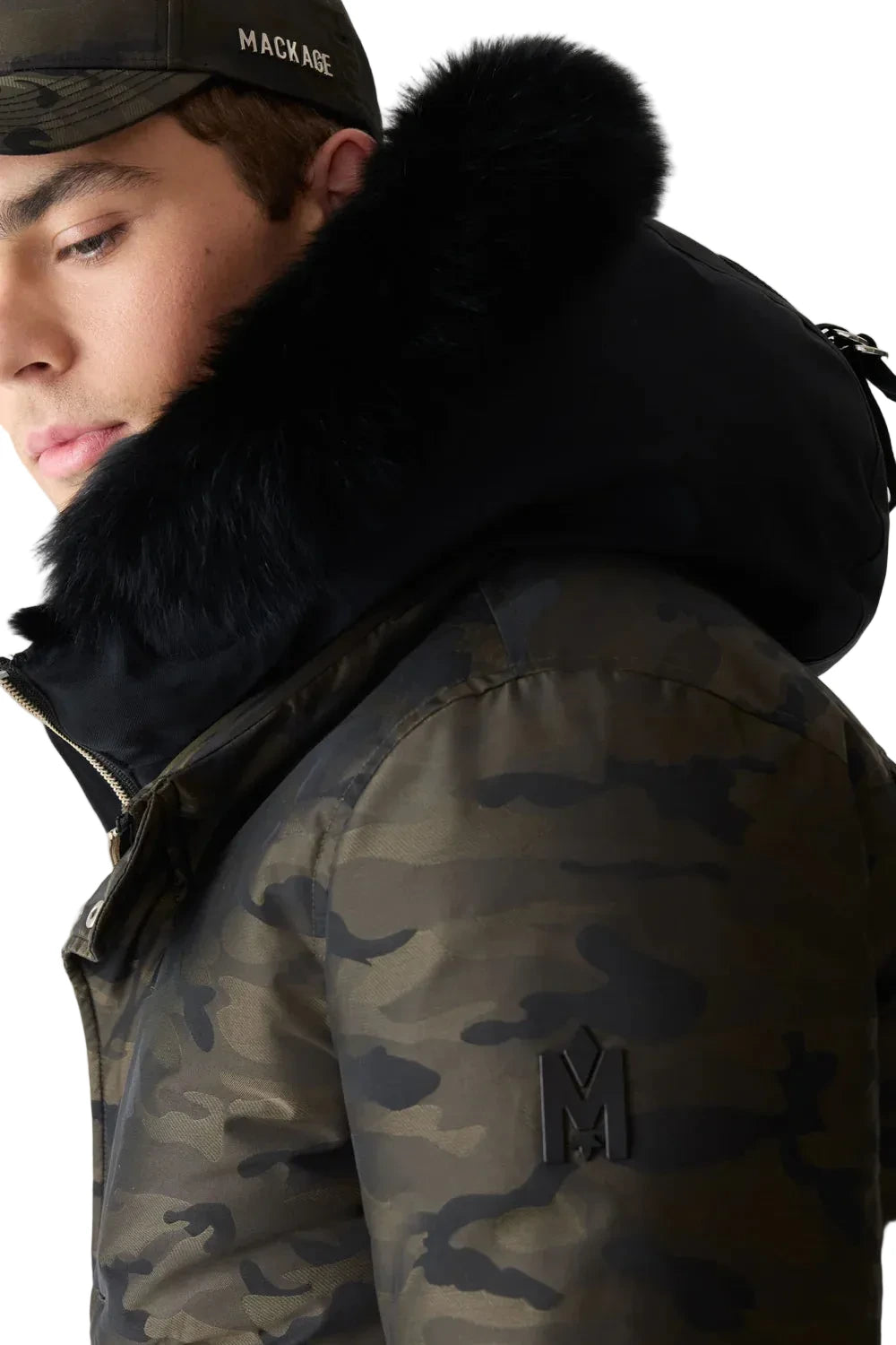 Mackage DIXON-JCZ down-filled bomber jacket with removable bib, fur-trimmed hood, and jacquard camouflage pattern.