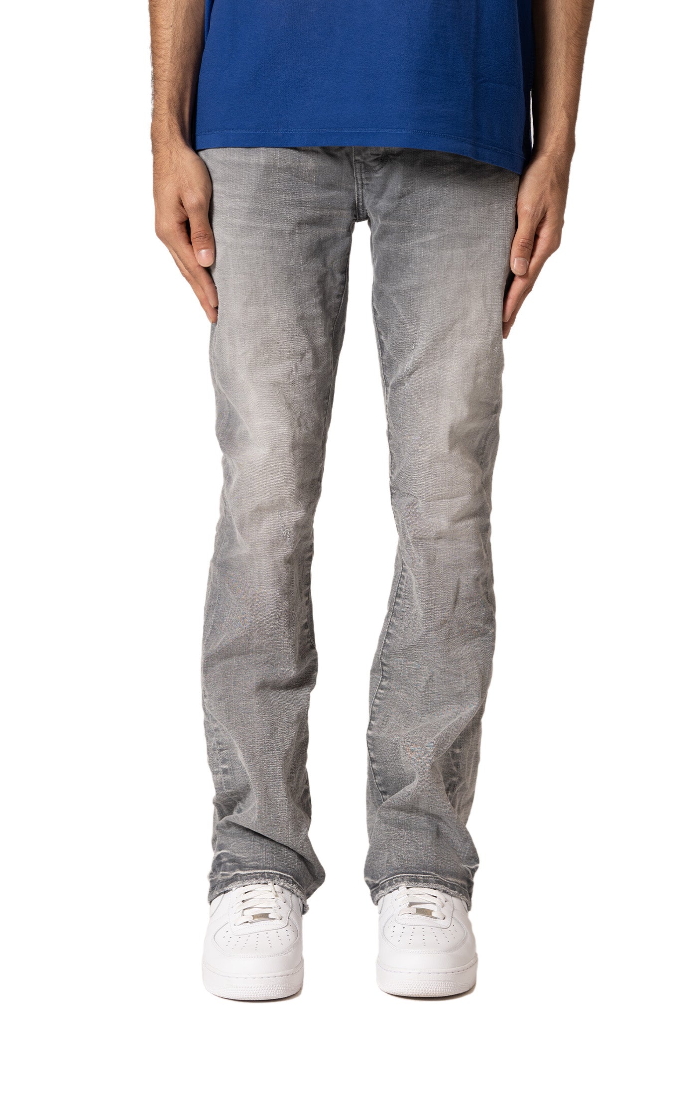 Purple Brand P004 low-rise flared jeans in hand-faded grey wash with premium stretch denim laid flat