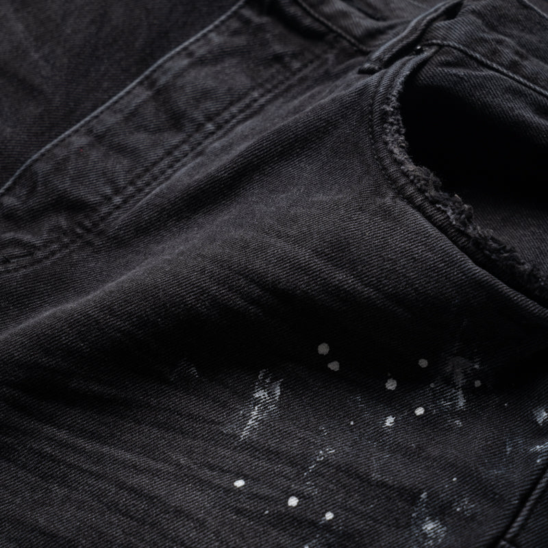Purple-Brand mid-rise straight-leg jeans in black with knee slit, paint splatter detailing, and signature hangtag.